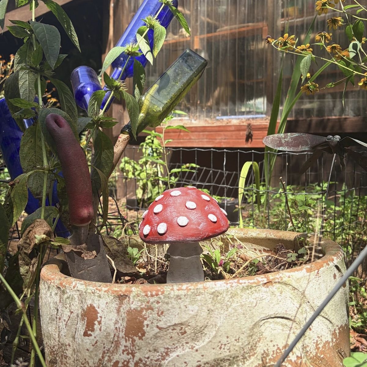 Cement statues placed in a planted garden